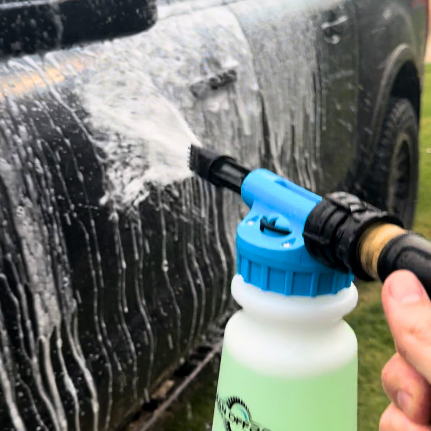 Foam gun applying No Bulldust to a muddy 4WD