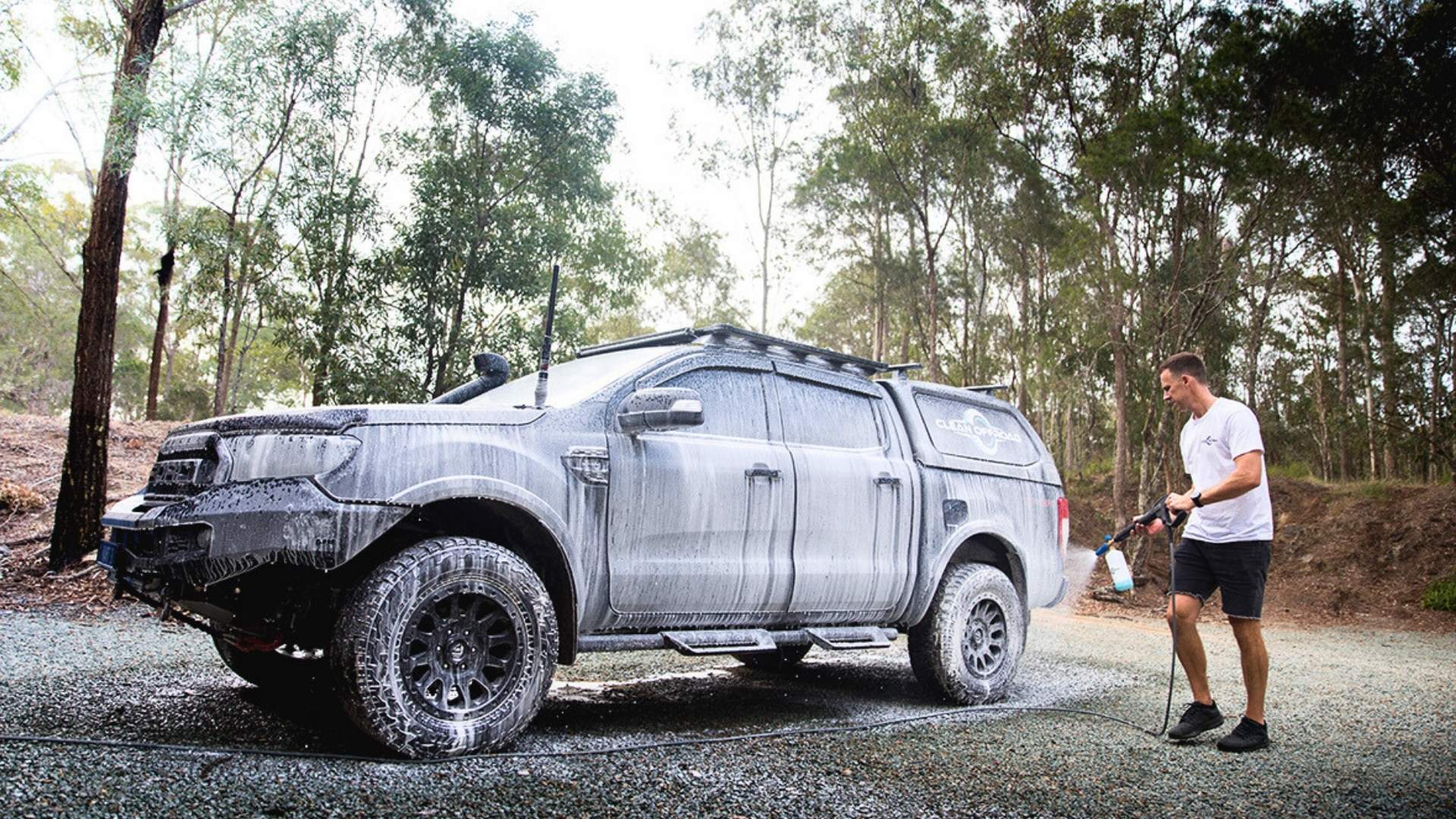Foam cannon washing offroad vehicle after a muddy adventure