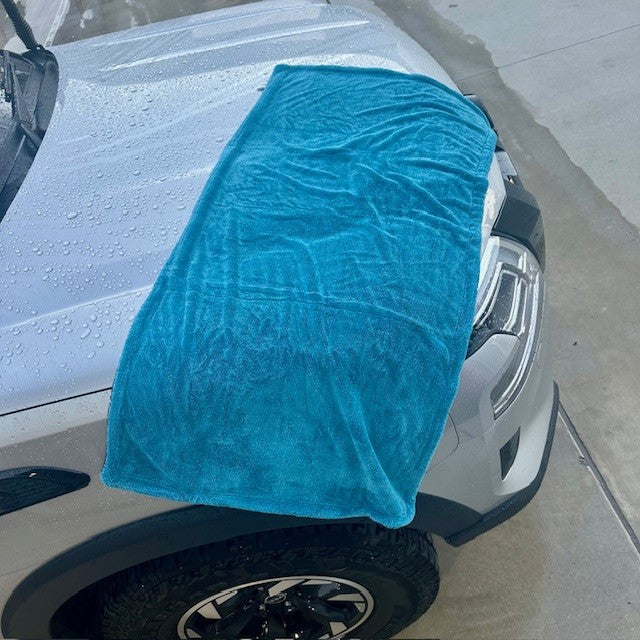 Titan Towel spread across a 4WD bonnet, demonstrating large size and fast drying capability